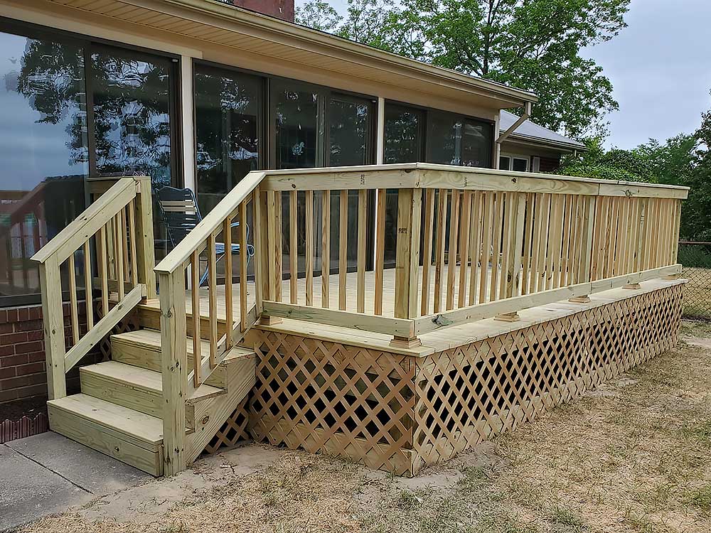 Pressure treated lumber deck with stairs and lattice skirting, offering a durable and attractive outdoor living space.